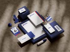 Blue and white branded boxes arranged on a gray textured surface, with small cards and a tube nearby.